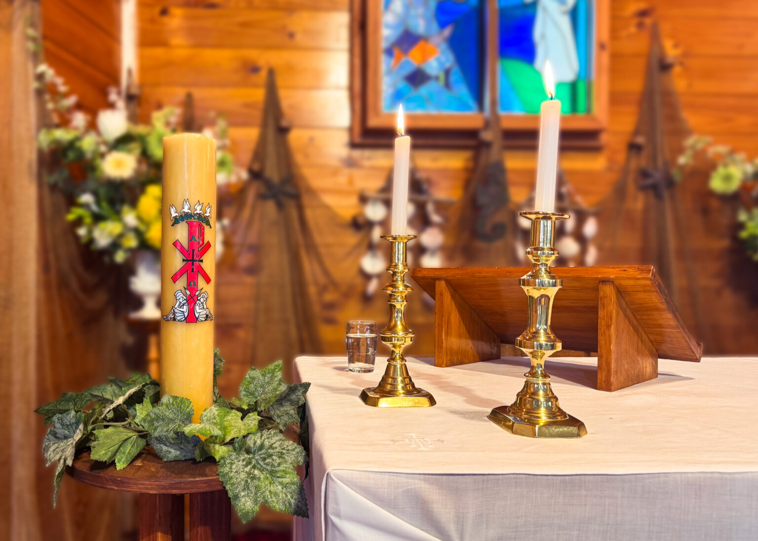 Altar with paschal candle at St Peter the Fisherman in Whitianga, New Zealand.
