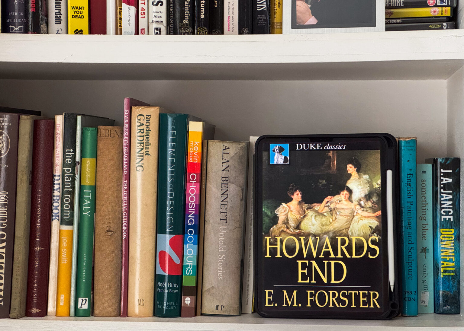 Howard's End by E.M. Forster displayed on a bookshelf full of books